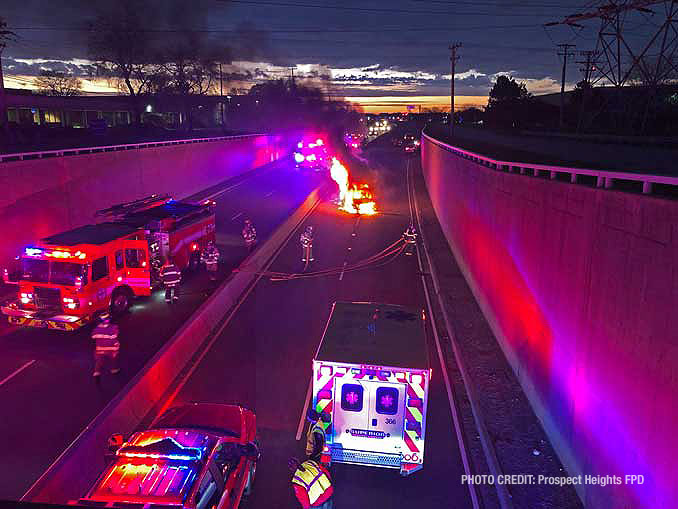 Minivan driven by wrong way driver burning in eastbound express lanes of Palatine Road west of Wolf Road (PHOTO CREDIT: Prospect Heights Fire Protection District).