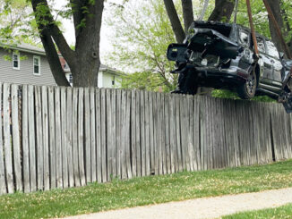 A Toyota SUV lifted over a fence by Hillside Service using a rotator crane tow truck on Monday, May 17, 2021