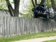 A Toyota SUV lifted over a fence by Hillside Service using a rotator crane tow truck on Monday, May 17, 2021