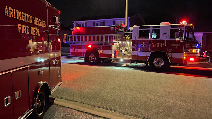 Arlington Heights Fire Department Engine 4 pumping water in front of house where a fire pit ignited a patio deck