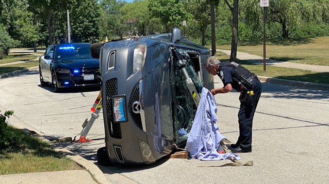 Police checking a car vs tree rollover crash on Heritage Drive Mount Prospect