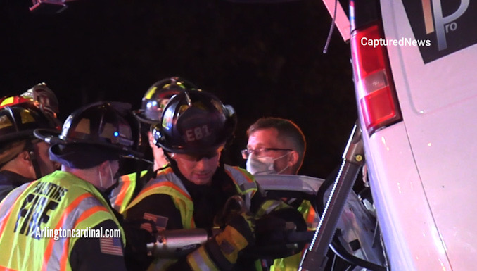 Extrication on the driver's side of a Chevrolet work van with a strut stabilizing the van