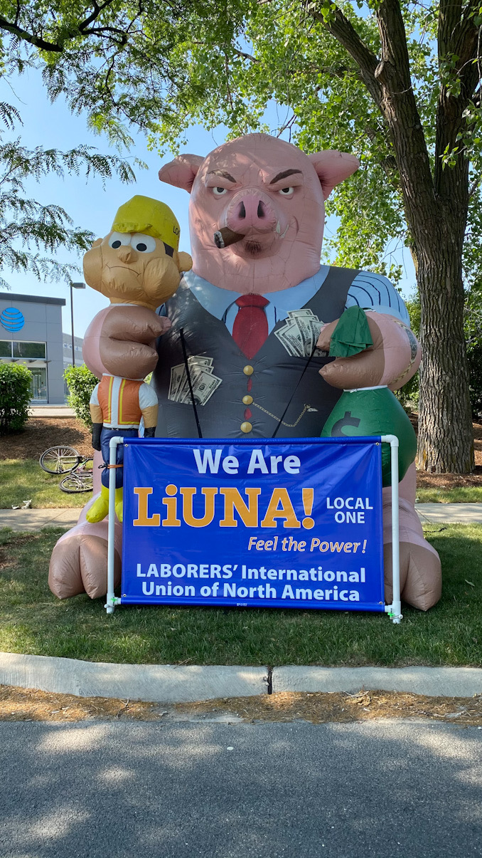 Inflatable pig with cash with banner that says, "We Are LiUNA! Local One Laborers' International Union of North America."