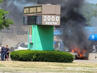 Good Samaritans carry man from burning car at a America's Best Car Wash in Mount Prospect on South Elmhurst Road in Mount Prospect