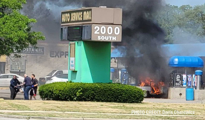 Good Samaritans carry man from burning car at a America's Best Car Wash in Mount Prospect on South Elmhurst Road in Mount Prospect