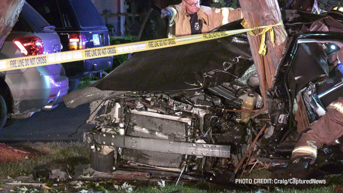 Fatal crash scene shows firefighters working to free occupants of a Dodge Charger that hit a utility pole on Dugdale Road in Waukegan on Saturday, July 24, 2021