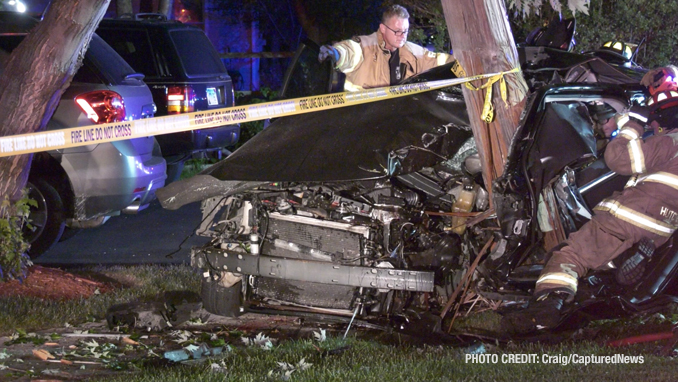 Fatal crash scene shows firefighters working to free occupants of a Dodge Charger that hit a utility pole on Dugdale Road in Waukegan on Saturday, July 24, 2021