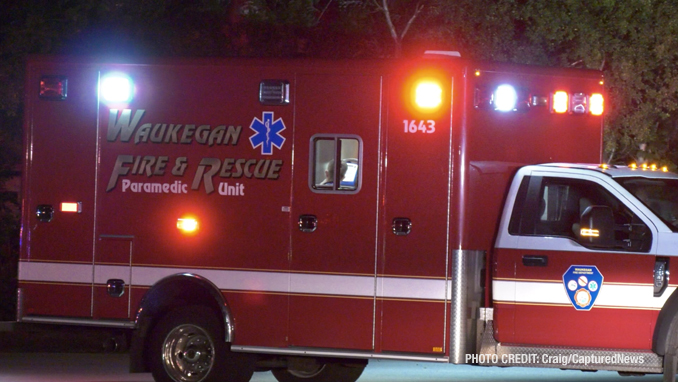 Waukegan Fire Department ambulance at a fatal crash scene after the driver of a Dodge Charger hit a Honda Civic and then a utility pole on Dugdale Road in Waukegan on Saturday, July 24, 2021