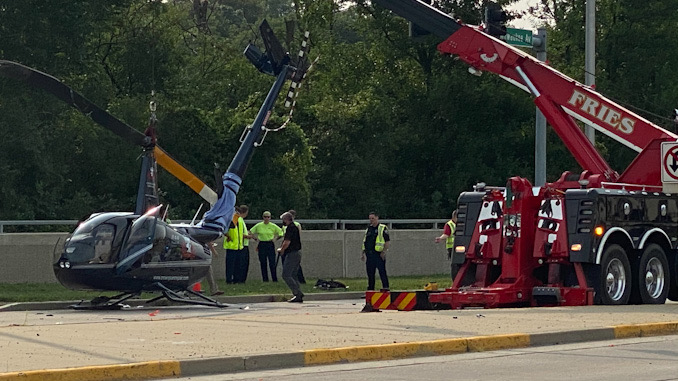 Helicopter uprighted before it was lifted onto a flatbed truck