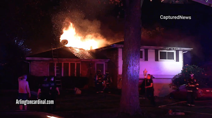 House fire on Mark Drive in Mount Prospect with fire through the roof after chimney collapse.