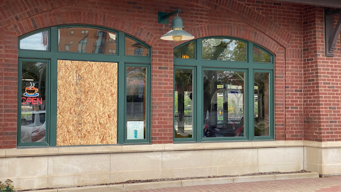 Boarded up window opening where burglars hit the downtown Arlington Heights Metra station at 45 West Northwest Highway