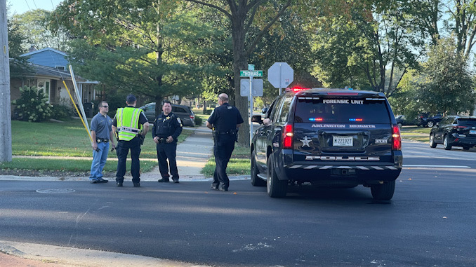 Arlington Heights police officers working at the scene of a hit-and-run pedestrian crash at Thomas Street and Hickory Avenue in Arlington Heights