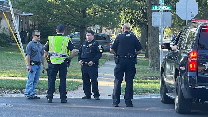Arlington Heights police officers working at the scene of a hit-and-run pedestrian crash at Thomas Street and Hickory Avenue in Arlington Heights