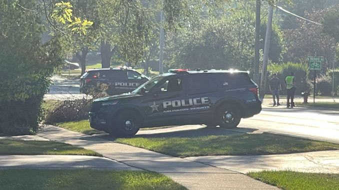 Arlington Heights police officers working at the scene of a hit-and-run pedestrian crash at Thomas Street and Hickory Avenue in Arlington Heights