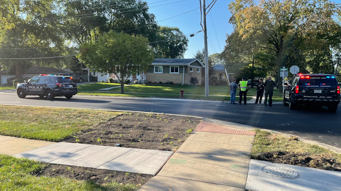 Arlington Heights police officers working at the scene of a hit-and-run pedestrian crash at Thomas Street and Hickory Avenue in Arlington Heights