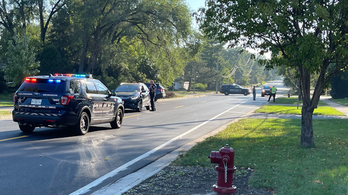 Arlington Heights police officers working at the scene of a hit-and-run pedestrian crash at Thomas Street and Hickory Avenue in Arlington Heights