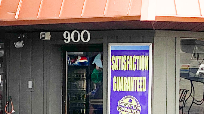 Workers from Suburban Trim & Glass repairing glass door at Northwest Auto Wash after the business was vandalized about 2:40 a.m. Thursday, September 23, 2021