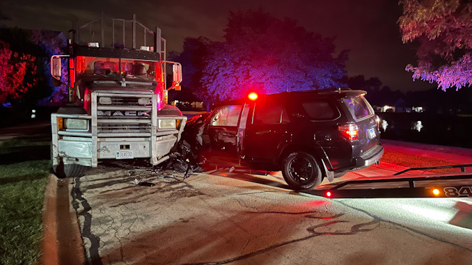 Black Toyota 4Runner crash into a Mack Truck