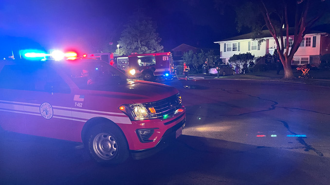 Fire command in the foreground with a view of crews working on High Grove Lane in Palatine