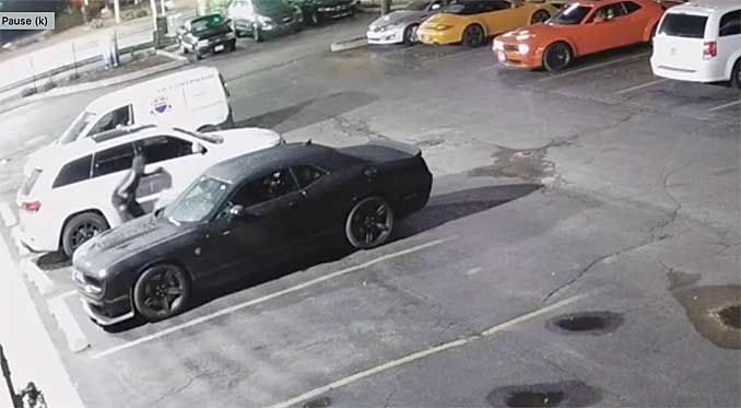 AUTO THEFT IN PROGRESS: Suspect crouching at the scene while auto theft of Dodge Challenger SRT Hellcat is underway (SOURCE: Security video at scene on Harlem Avenue near Addison Street Chicago)