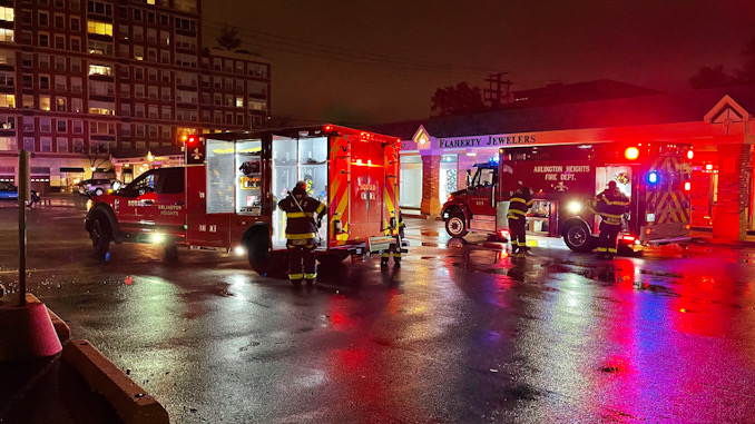 Crews picking up gear and securing personal protective equipment after a smoke investigation and ventilation at Sweet T's Bakery & Cake Studio on South Dunton Avenue in Arlington Heights