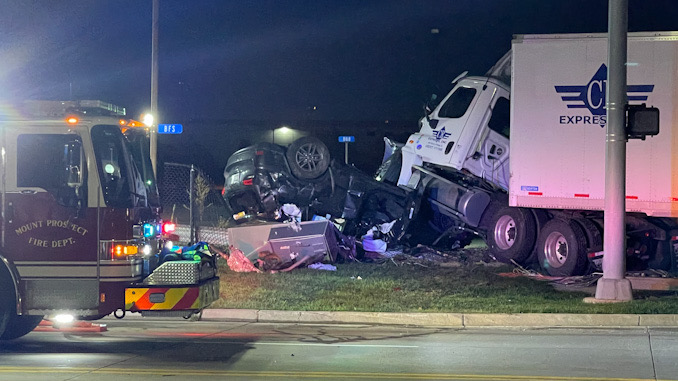 Semi-tractor on top of rolled over Jeep SUV at Dempster Street and Linneman Road in Mount Prospect.