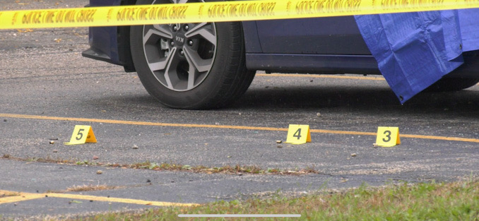 Evidence markers near a blue Kia sedan at the scene of a fatal shooting in Park City (SOURCE: Craig/CapturedNews)