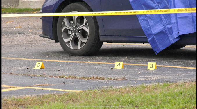 Evidence markers near a blue Kia sedan at the scene of a fatal shooting in Park City (SOURCE: Craig/CapturedNews)