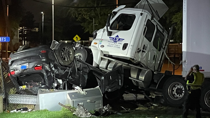 Semi-tractor on top of rolled over Jeep SUV at Dempster Street and Linneman Road in Mount Prospect.