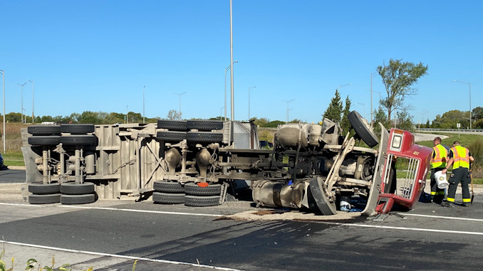 Underside of a rolled over semi-trailer dump truck in the eastbound lanes of Palatine Road just east of Route 53