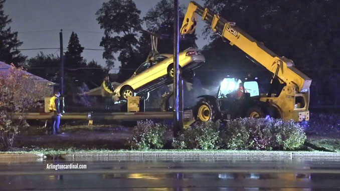 Car lifted off railroad tracks by Hillside Towing using JCB Telehandler construction east of Mount Prospect Road