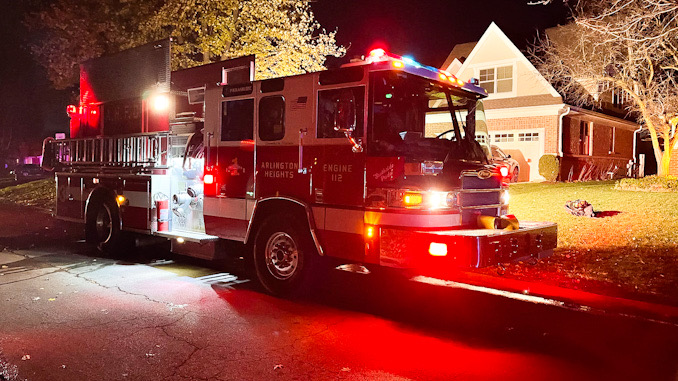 Firefighters at the scene of an outdoor fire involving a compost pile in windy conditions in a backyard between Highland Avenue and Vail Avenue in Arlington Heights