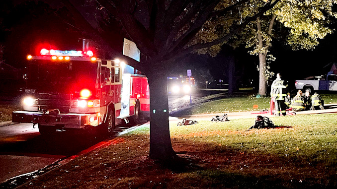 Firefighters at the scene of an outdoor fire involving a compost pile in windy conditions in a backyard between Highland Avenue and Vail Avenue in Arlington Heights