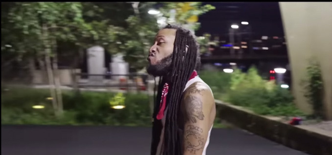 Still frame in rap video showing Darrell Brooks' tattoos on left shoulder and left arm