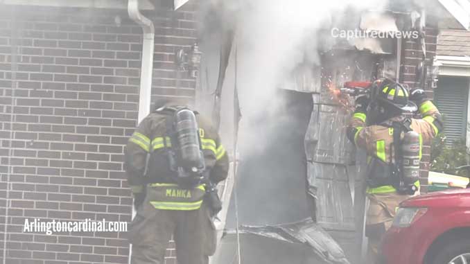 Cutting the garage door out of the way at a house fire on Greenridge Road in Buffalo Grove, Thanksgiving Day, November 25, 2021