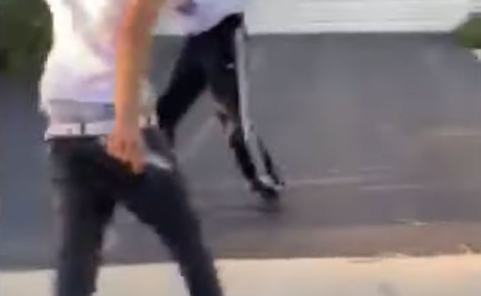 Knife closeup, zoomed in on seventeen year-old stabbing suspect (left) with the knife in his right hand (Bystander cellphone video evidence during stabbing)