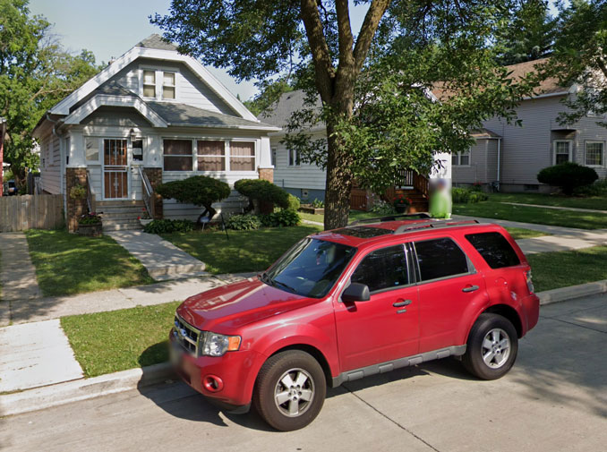 Red Ford Escort parked directly in front of 4014 North 19th Street, Milwaukee