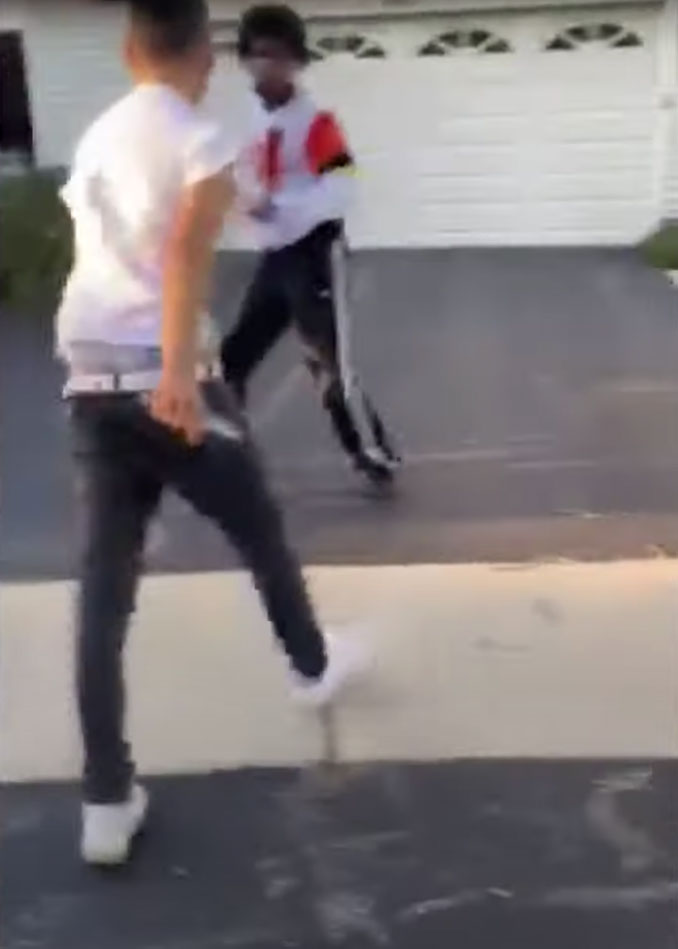 Seventeen year-old stabbing suspect (left) with a knife in his right hand (Bystander cellphone video evidence during stabbing)