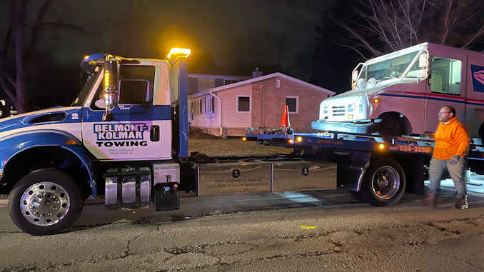 USPS van on a tow truck after a crash with an SUV at Yale Avenue and Marion Road/Illinois Avenue in Arlington Heights.