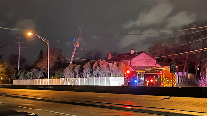 Engine 2's crew comes out after Engine 4 checked earlier -- a large utility pole carrying ComEd primary lines severed at the base and leaning toward house near Palatine Road west of Windsor Drive in Arlington Heights