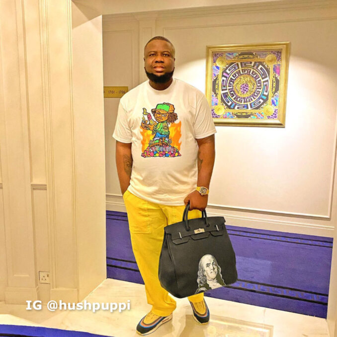 Hushpuppi wearing gold and carrying a bag with Ben Franklin image on side (Instagram.com/hushpuppi)