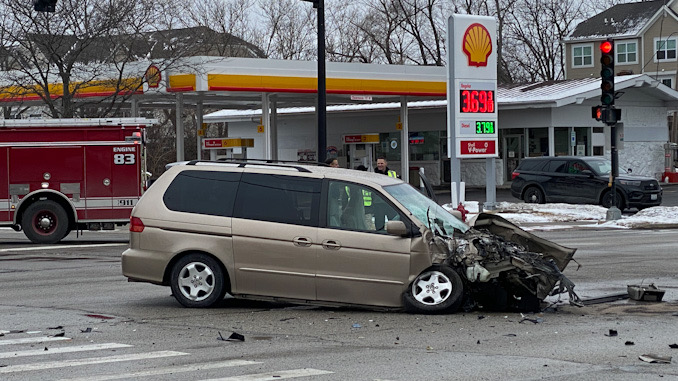 Minivan with severe front-end damage after a crash kwith a Palatine fire engine.