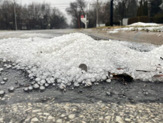 Hail pile near catch basin on Douglas Avenue south of Hintz Road