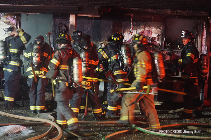 Firefighters at the front of a home destroyed by fire on 3rd Avenue in Cary, Illinois (PHOTO CREDIT: Jimmy Bolf)