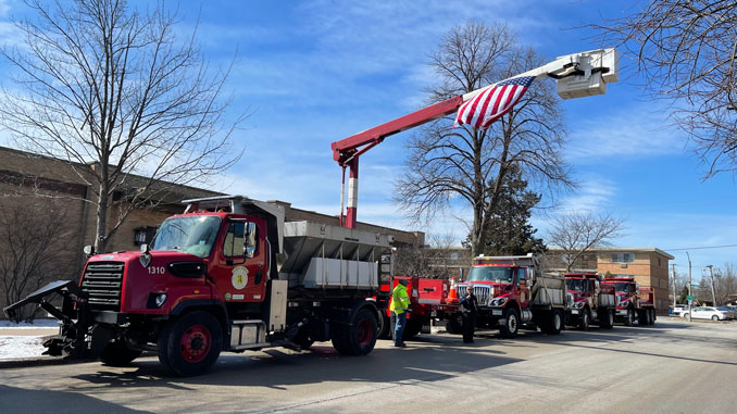 US Flag flying with Arlington Heights Public Works aerial bucket truck