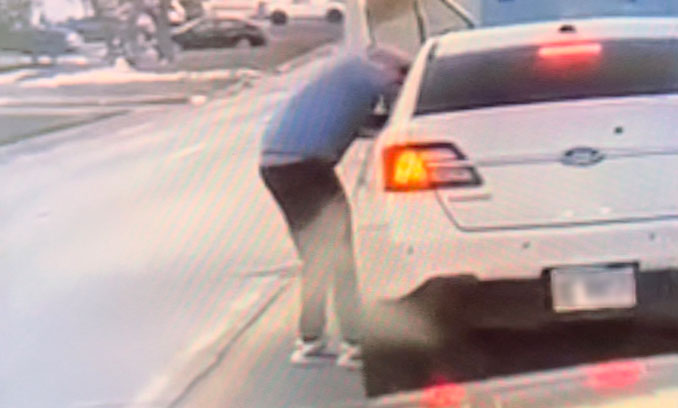 Mattison with his arm inside the shooter's window in the Ford Taurus (Twitter.com)