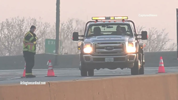 Firefighter and tow truck driver on the Route 53 overpass over Palatine Road Sunday morning April 3, 2022
