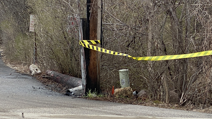 A charred utility pole after a fire on the north side of Robert Parker Coffin Road