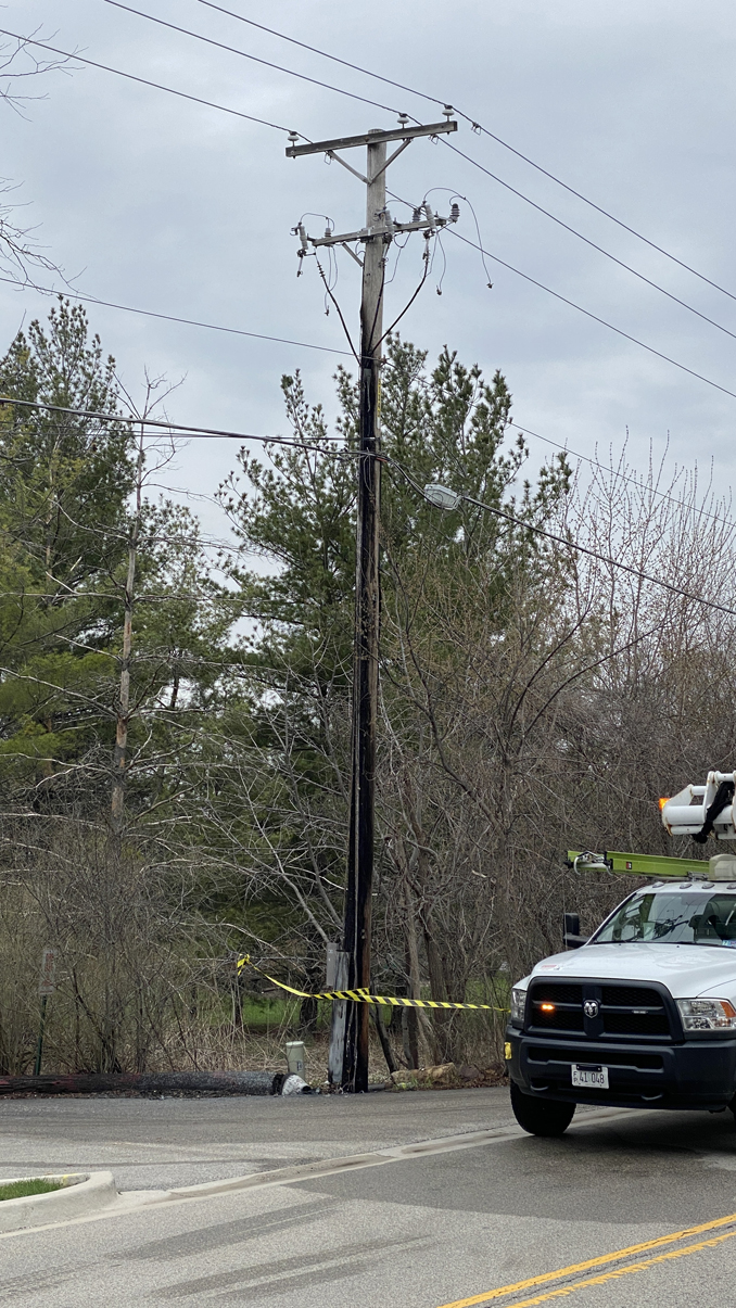 A charred utility pole after a fire on the north side of Robert Parker Coffin Road