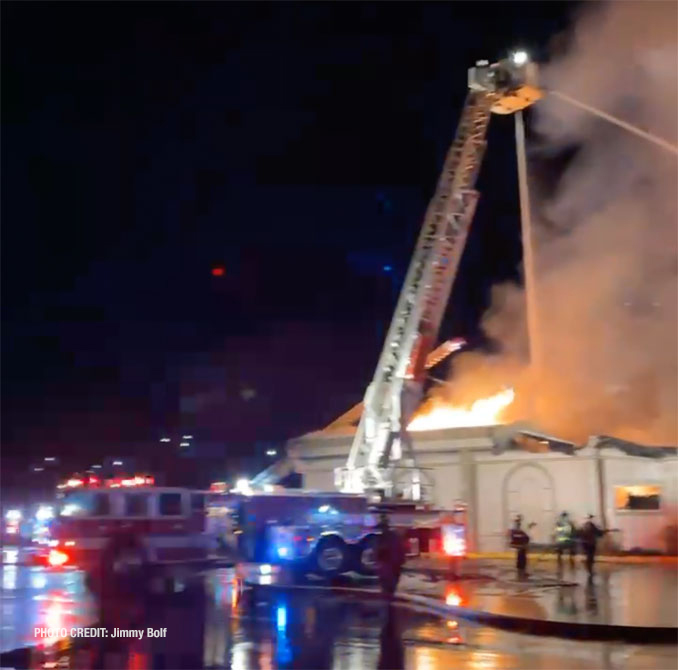 Tower ladder at work at fire scene at D'Andrea Banquets and Conference Center early Saturday morning, April 16, 2022 (PHOTO CREDIT: Jimmy Bolf)